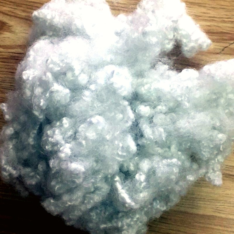 Hollow conjugate siliconized polyester fiber for filling
